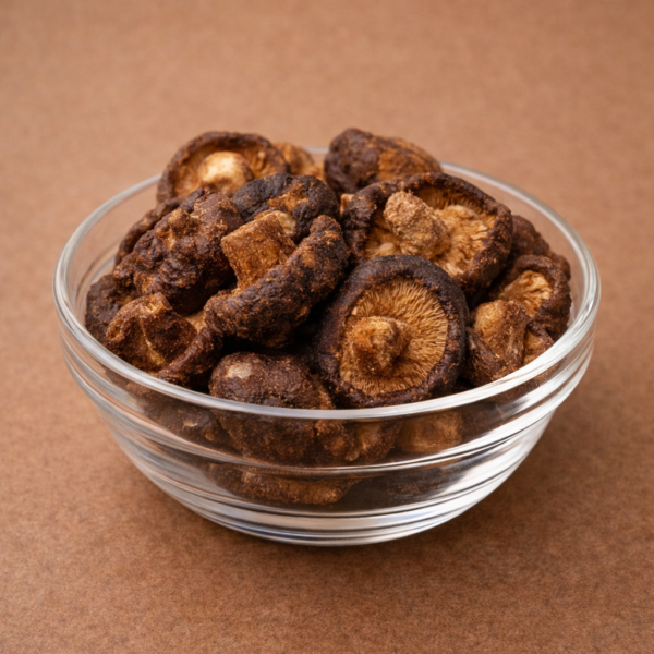 Crispy mushroom slices served in a small glass bowl on a neutral background